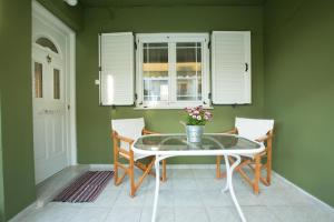 a dining room with a glass table and chairs at Marietta's Townhouse in Argostoli