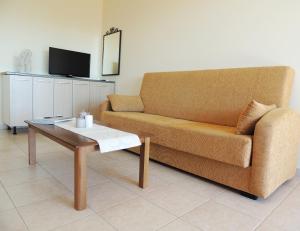 a living room with a couch and a coffee table at Maria-Villa in Psakoudia