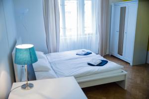 a bedroom with a bed with two towels on it at Budget Apartment in Prague
