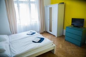 a bedroom with a bed with two towels on it at Budget Apartment in Prague