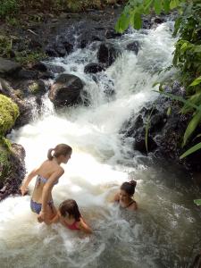 three children playing in the water in a waterfall at Mi Casa - The gem of Ijen in Banyuwangi