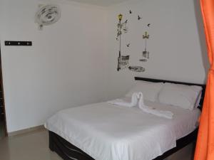 Postel nebo postele na pokoji v ubytování Hotel Campestre La Toscana
