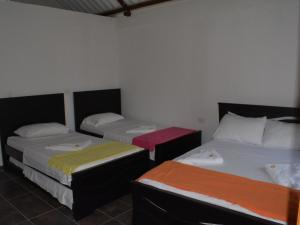 Postel nebo postele na pokoji v ubytování Hotel Campestre La Toscana