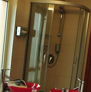 a shower with a glass door in a bathroom at Hotel Santo in Karlsruhe +27 photos