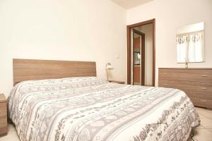 a bedroom with a large bed and a dresser at Casa Mare Blu codice CITRA OO9O34 LT 1168 in Loano
