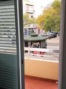 a window with a view of a street with a building at Faro Downtown Holiday Apartment in Faro