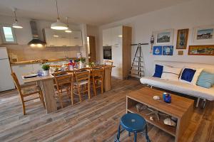 a living room with a kitchen and a dining room and a living room at Apartment Christian in Karlobag