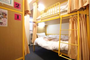 a bedroom with bunk beds in a room at Sakura Hotel Ikebukuro in Tokyo