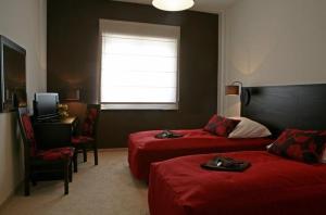 a hotel room with two beds and a window at Hotel Altamira in Piotrków Trybunalski +22 photos
