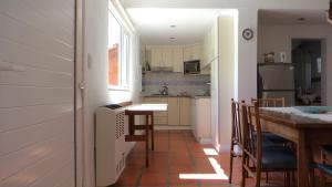 a small kitchen with a table and a dining room at Rincón De Angeles in Tandil
