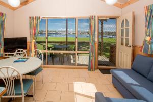 a living room with a couch and a table at BIG4 Batemans Bay at Easts Riverside Holiday Park in Batemans Bay