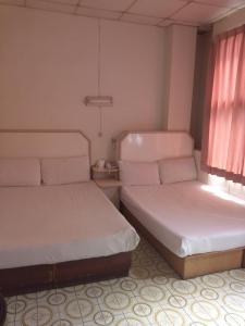Tempat tidur dalam kamar di Yongxing Inn