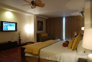 A bed or beds in a room at The Lalit Temple View
