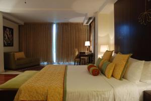 A bed or beds in a room at The Lalit Temple View