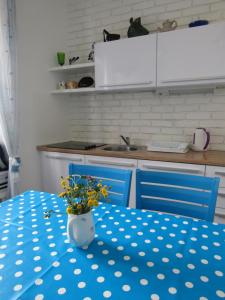 Holiday Home Isabella في فيس: مطبخ مع طاولة مع قطعة قماش من البولكا الزرقاء والبيضاء