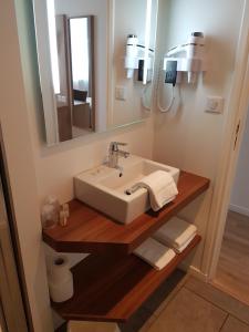 a bathroom with a sink and a mirror at Hôtel Mary's - Caen Centre Gare Sncf in Caen