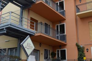 a sign in front of a building with balconies at La Lanterna Hotel in Rometta Marea