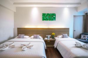 Postel nebo postele na pokoji v ubytování Crystal Crown Hotel Petaling Jaya