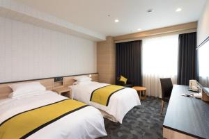 Postel nebo postele na pokoji v ubytování Hotel Hewitt Koshien