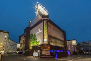 a large building with a sign on top of it at Hotel Noah Resort Sakuranomiya (Adult Only) in Osaka