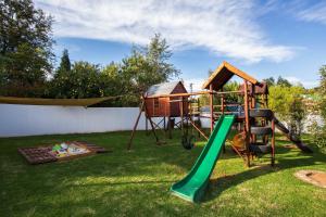 a playground in a yard with a slide at The Browns' Luxury Suites & Cottage in Dullstroom