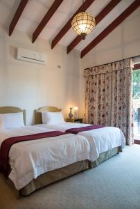 a bedroom with a large bed and a window at La Casa Compartida in Southbroom +24 photos