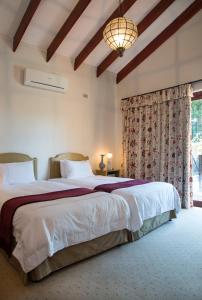 a bedroom with a large bed and a window at La Casa Compartida in Southbroom