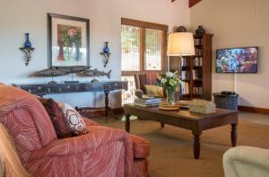 a living room with a couch and a coffee table at La Casa Compartida in Southbroom