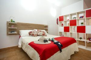 a bedroom with a bed with a hat on it at Sicily Mon Amour Ortigia in Siracusa