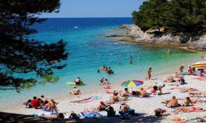 a group of people on a beach in the water at Apartment Niksa in Pula +14 photos