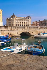 a group of boats docked in the water near a bridge at Sicily Mon Amour Ortigia in Siracusa