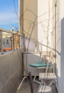 a balcony with a table and a chair and a window at Selection Rooms in Belgrade