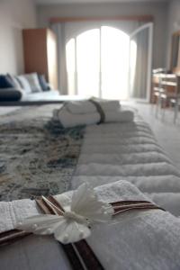 a hotel room with a row of white towels with a bow at Miva Sea View in Faliraki
