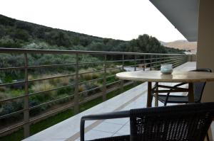 a patio with a table and chairs on a balcony at Marathon Eco Stay in Marathon