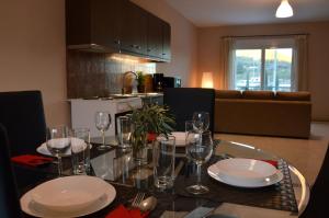a dining room table with plates and glasses on it at Marathon Eco Stay in Marathon