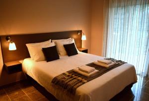 a bedroom with a large bed with towels on it at Marathon Eco Stay in Marathon