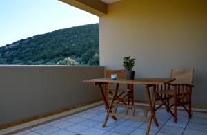 a table and chairs on a balcony with a view at Marathon Eco Stay in Marathon