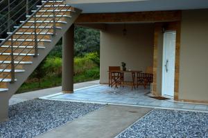 a patio with a staircase and a table and chairs at Marathon Eco Stay in Marathon