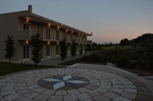a building with a stone circle in front of a building at Marathon Eco Stay in Marathon
