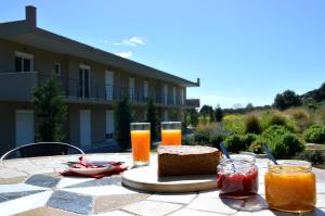 a table with bread and glasses of orange juice at Marathon Eco Stay in Marathon