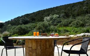 a table with glasses of orange juice on it at Marathon Eco Stay in Marathon