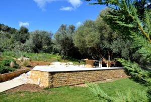 a brick retaining wall with a patio in a garden at Marathon Eco Stay in Marathon
