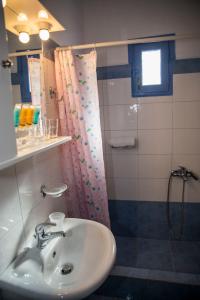 a bathroom with a sink and a shower at Togias Hotel in Aegina Town