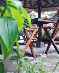 a wooden picnic table in front of a building at Arriani Homestay in Karimunjawa