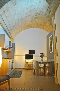 een keuken en eetkamer met een tafel en een plafond bij ragusa curtigghiu in Ragusa