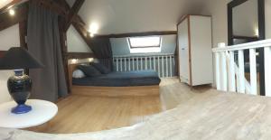 a bedroom with a bed and a stair case at Loft Zola in Dijon