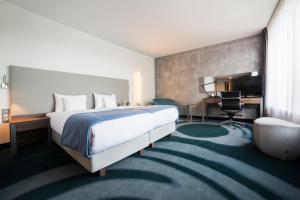 a hotel room with a bed and a desk at Przystań Hotel&Restaurants in Olsztyn +48 photos