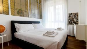 a bedroom with a bed with towels on it at Italianway-Dogana in Milan