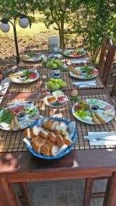 a picnic table with plates of food on it at Doga Apartments in Kayakoy