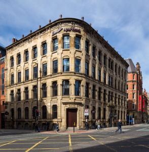 an old building on the corner of a street at Roomzzz Manchester City in Manchester
